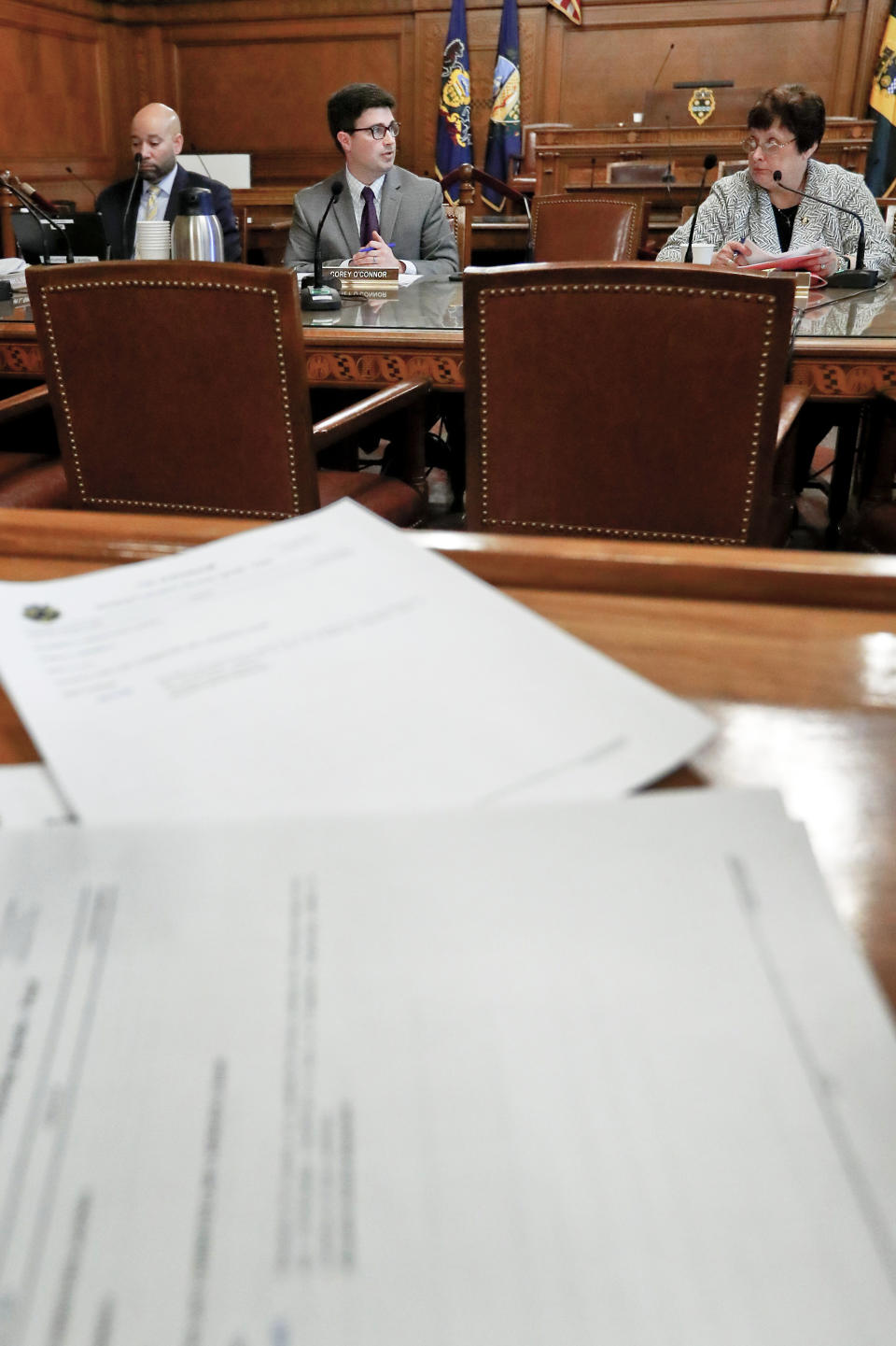 The agenda for the Pittsburgh City Council meeting is in front of council members, Robert Daniel Lavelle, left, Corey O'Connor, center, and Darlene Harris as the council discusses a vote on gun-control legislation, Wednesday, March 27, 2019, in Pittsburgh. The council voted 6-3 to approve a package of bills that would, among other things, place restrictions on military-style assault weapons like the one used in the synagogue attack last year. A final vote will take place next week. (AP Photo/Keith Srakocic)