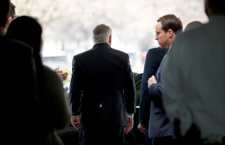 State Department workers applaud outgoing U.S. Secretary of State Rex Tillerson as he walks out the front door of the State Department in Washington, U.S., March 22, 2018. REUTERS/Kevin Lamarque