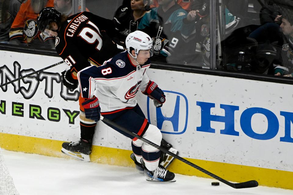 Columbus Blue Jackets defenseman Zach Werenski (8) takes the puck away from Anaheim Ducks center Leo Carlsson (91) during the third period of an NHL hockey game in Anaheim, Calif., Wednesday, Feb. 21, 2024. (AP Photo/Alex Gallardo)