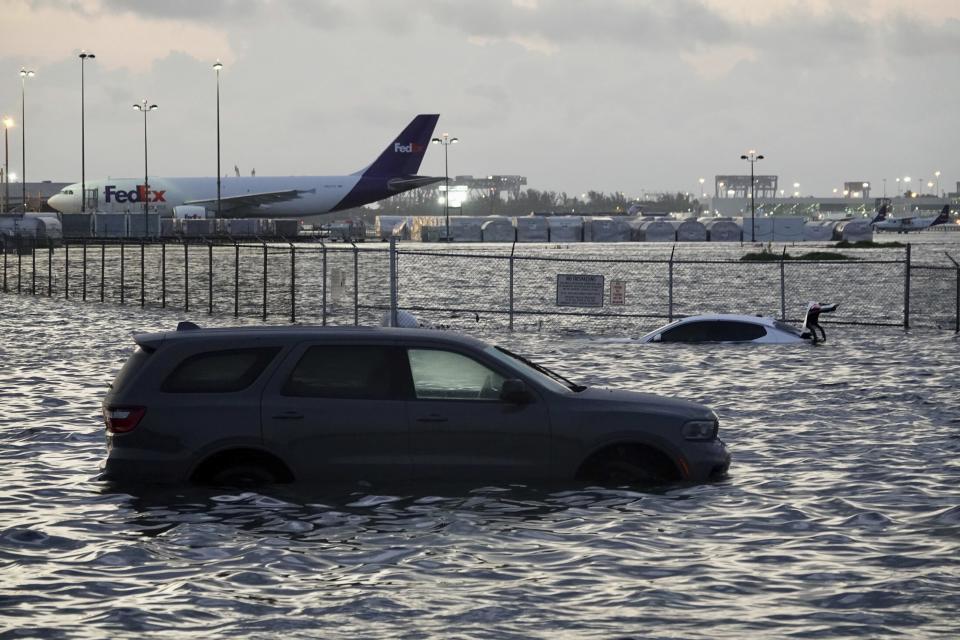 FILE - Flooding lingers at Fort Lauderdale-Hollywood International Airport on April 13, 2023, after heavy rain pounded South Florida. Over 25 inches of rain fell in South Florida since Monday, causing widespread flooding. (Joe Cavaretta /South Florida Sun-Sentinel via AP)