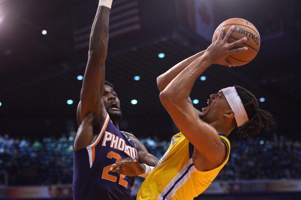 Feb 29, 2020; Phoenix, Arizona, USA; Golden State Warriors guard Damion Lee (1) shoots over Phoenix Suns center Deandre Ayton (22) during the second half at Talking Stick Resort Arena.