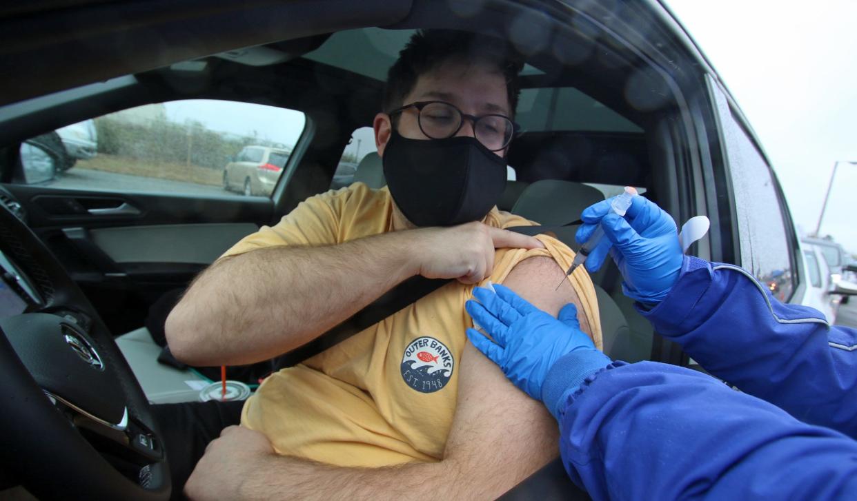 Max Pickler gets his vaccination shot in the rain as Kintegra Health and Livent teamed up to host a free drive through COVID-19 vaccination clinic in the Livent parking area on Bessemer City-Kings Mountain Highway in this Gazette file photograph.