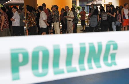 Voters queue to cast their ballots during the general election at a polling center in Singapore September 11, 2015. REUTERS/Edgar Su