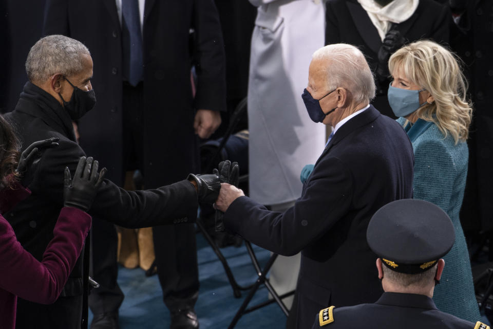 President-elect Joe Biden greets former President Barack Obama as he arrives at the West Front of the Capitol, Wednesday, Jan. 20, 2021, in Washington. (Caroline Brehman/Pool Photo via AP)