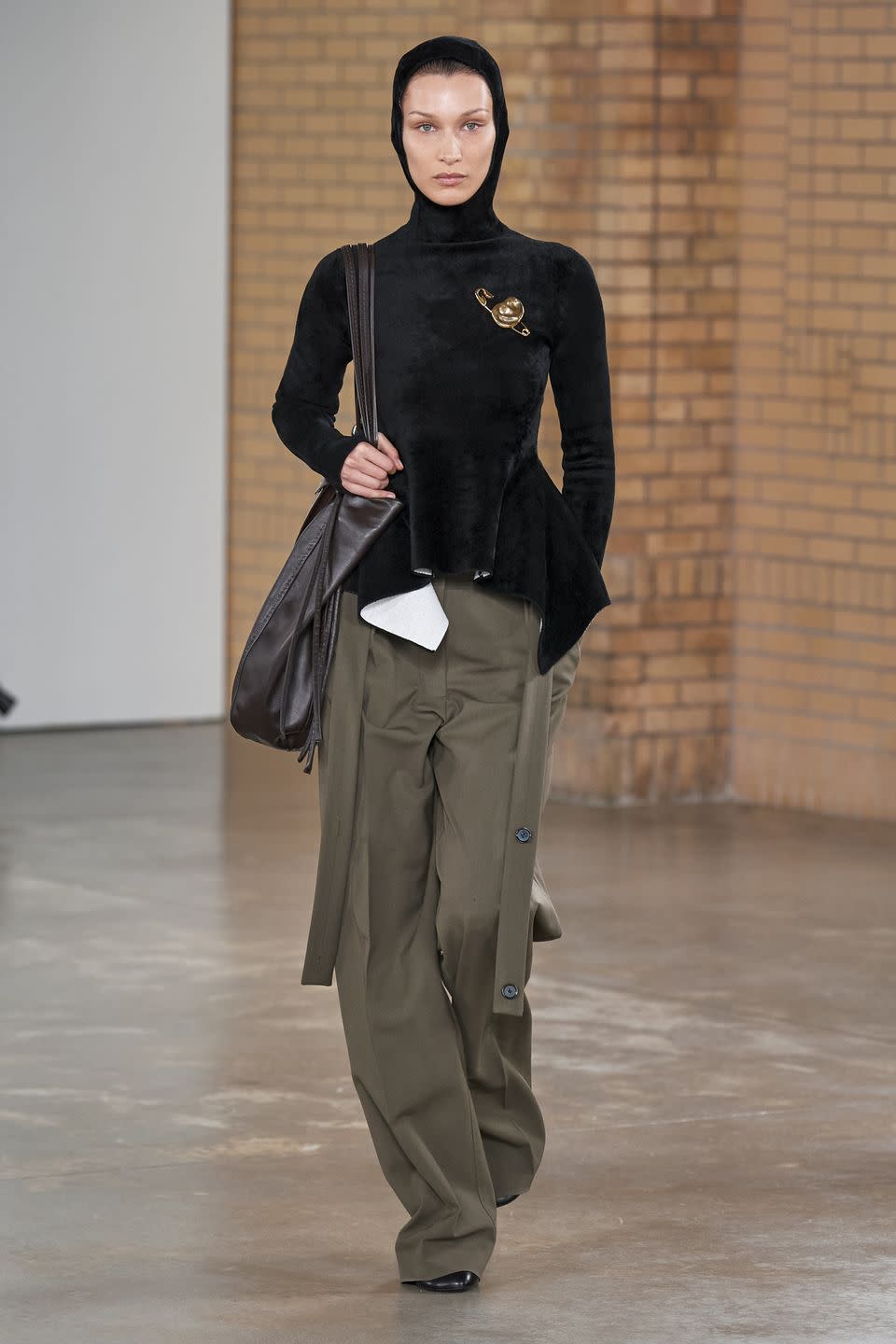 <p>Bella Hadid made her runway debut for AW22, appearing in the Proenza Schouler show at New York Fashion Week wearing a velvet, hooded top and baggy khaki trousers.<br></p>