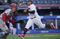 Cleveland Indians' Josh Naylor, right, scores as Cincinnati Reds catcher Tyler Stephenson waits for the throw during the second inning of a baseball game Saturday, May 8, 2021, in Cleveland. (AP Photo/Tony Dejak)