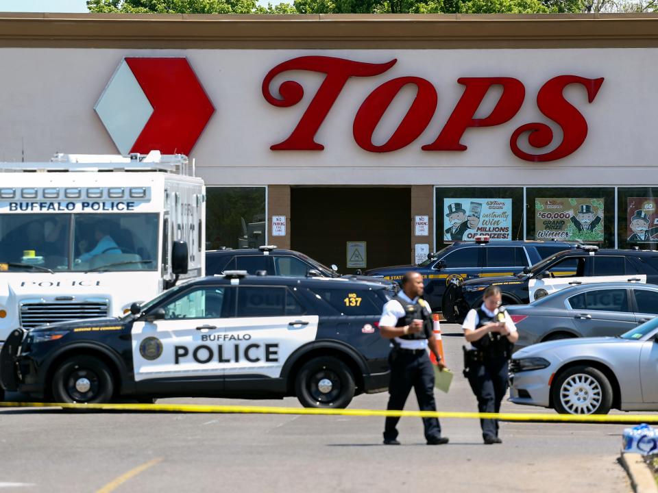 Police officers in front of grocery store.