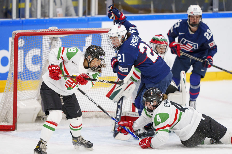 Hilary Knight of the United States, number 2, in action with Alexandra Huszak and Taylor Baker of Hungary during The IIHF World Championship Woman's ice hockey match between USA and Hungary in Herning, Denmark, Thursday, Sept. 1, 2022. (Bo Amstrup/Ritzau Scanpix via AP)