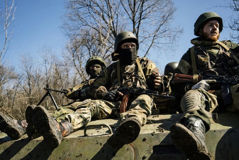 Armed pro-Russian rebels sit on top of an armoured personnel carrier as they take part in a military drill near the eastern city of Donetsk on April 10, 2015
