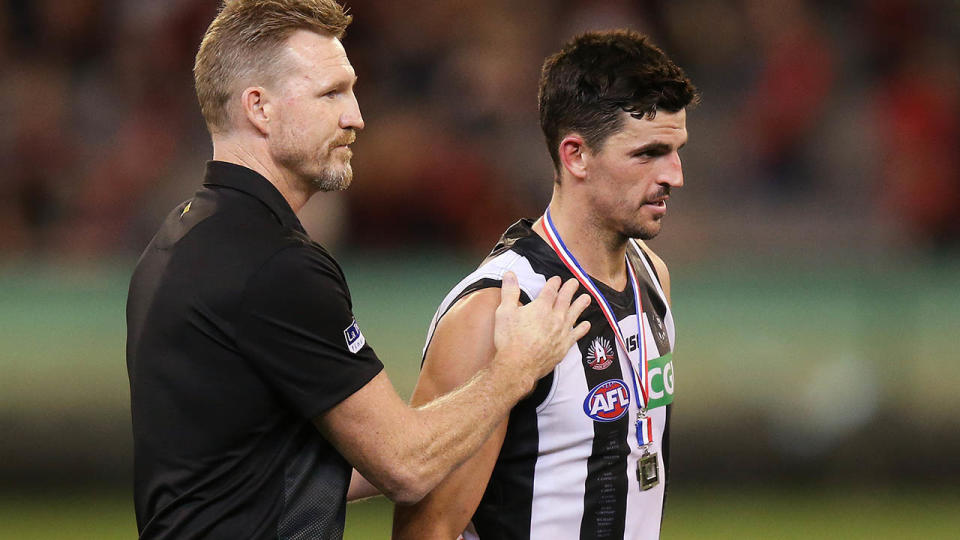 Nathan Buckley walks off with Scott Pendlebury after the ugly scenes. (Photo by Michael Dodge/Getty Images)