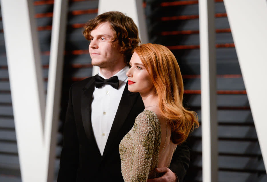 Emma Roberts and Evan Peters have hearts passing between them at the “Vanity Fair” Oscar party