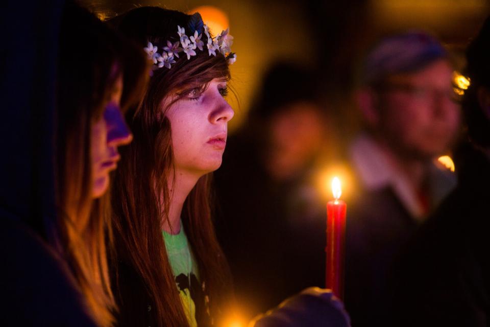 People attend a candlelight memorial honoring Kayla Mueller at the Prescott's Courthouse Square in Prescott, Arizona