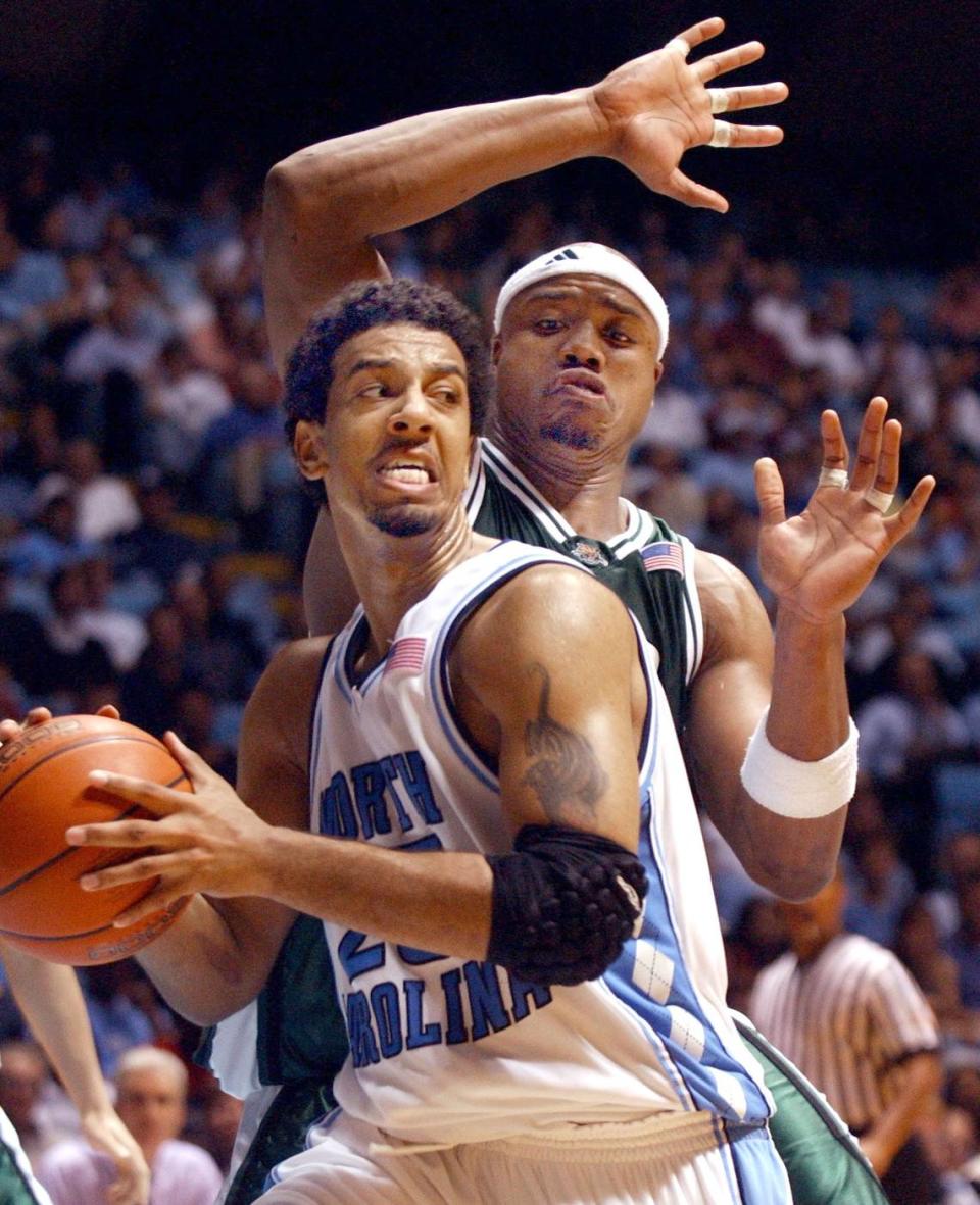 UNC’s Jason Capel works to pivot around Ohio’s Brandon Hunter on February 20, 2002. Staff Photo by Scott Sharpe