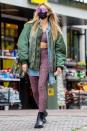 <p>Heidi Klum wears a green bomber jacket over a leopard-print workout set to go grocery shopping with her mom Erna in Berlin on Wednesday. </p>