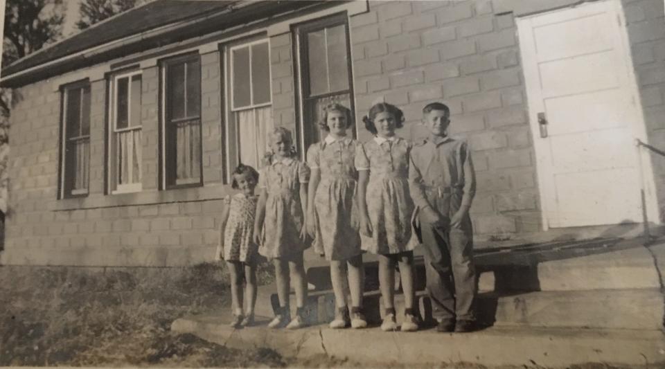 Students pose for a photo outside Maple Grove School in Dallas Township.