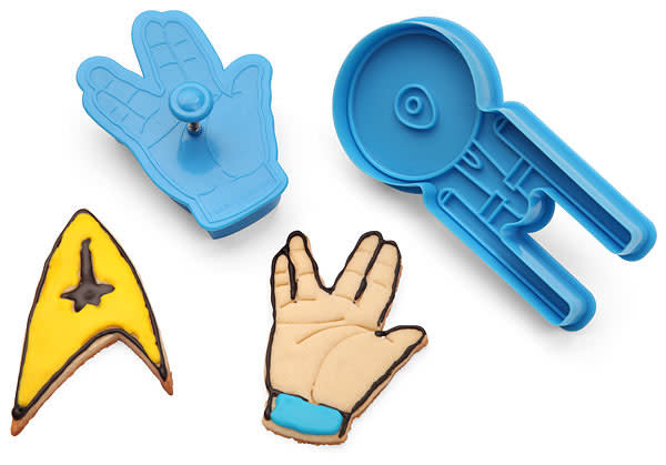 <b>GADGETS<br><br>"Star Trek" Cookie Cutters</b><br>(see previous slide)... because who isn't going to try to make off with as many Enterprise-shaped cookies as he can get his "Trek"-loving mitts on? The set includes a phaser, a Federation symbol, a Klingon Empire symbol, a "live long and prosper" gesture, and the Enterprise, and it comes in a cool "Trek" design package. <br><br><a href="http://www.thinkgeek.com/product/ed0a/" rel="nofollow noopener" target="_blank" data-ylk="slk:ThinkGeek.com;elm:context_link;itc:0;sec:content-canvas" class="link ">ThinkGeek.com</a>, $9.99
