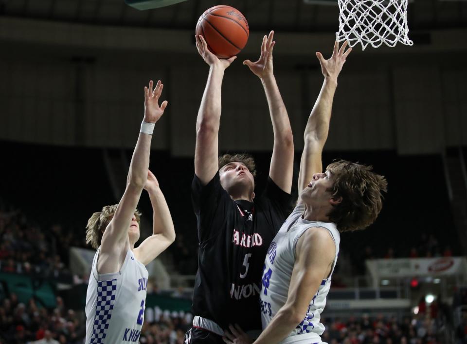 Fairfield Union senior Ted Harrah goes up for a shot in between a pair of Bishop Ready defenders during Saturday's Division II regional final at Ohio University's Convocation Center. The Falcons fell short, 48-33.