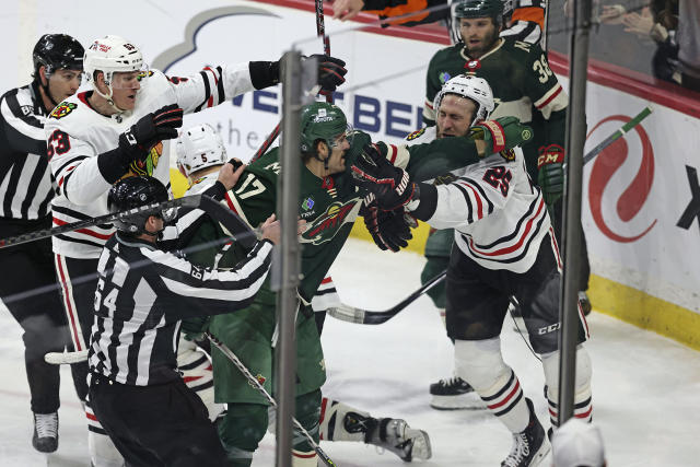 Minnesota Wild left wing Marcus Foligno (17) and Chicago Blackhawks defenseman Jarred Tinordi (25) fight during the third period of an NHL hockey game Saturday, March 25, 2023, in St. Paul, Minn. Minnesota won 3-1. (AP Photo/Stacy Bengs)