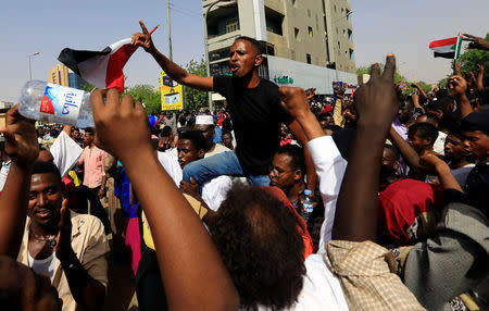 Sudanese demonstrators chant slogans as they protest against the army's announcement that President Omar al-Bashir would be replaced by a military-led transitional council, in Khartoum, Sudan April 11, 2019. REUTERS/Stringer