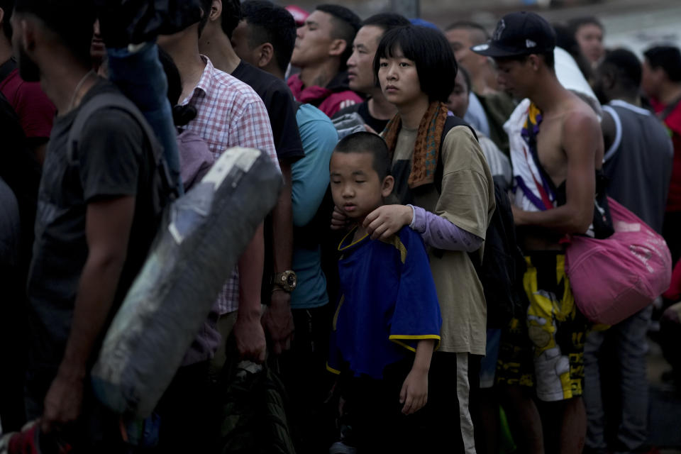 FILE - Chinese migrants line up to take a boat to Lajas Blancas after walking across the Darien Gap in Bajo Chiquito, Panama, May 7, 2023. (AP Photo/Natacha Pisarenko, File)
