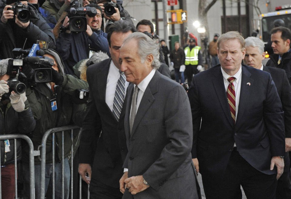 FILE - Bernard Madoff arrives at Manhattan federal court, Thursday, March 12, 2009, in New York. Madoff, the financier who pleaded guilty to orchestrating the largest Ponzi scheme in history, died early Wednesday, April 14, 2021, in a federal prison, a person familiar with the matter told The Associated Press. (AP Photo/ Louis Lanzano, File)