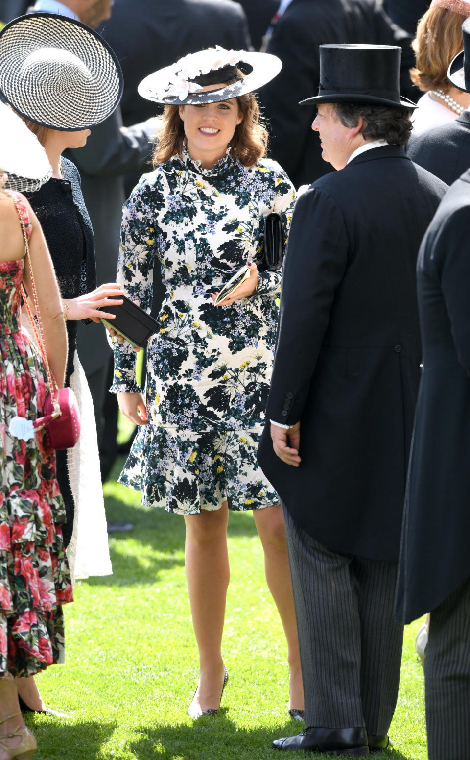 <p>Princess Eugenie is a big fan of floral numbers and she showed up at day three of Ascot rocking a pretty long-sleeved dress with a matching halo hat. Photo: Getty Images </p>