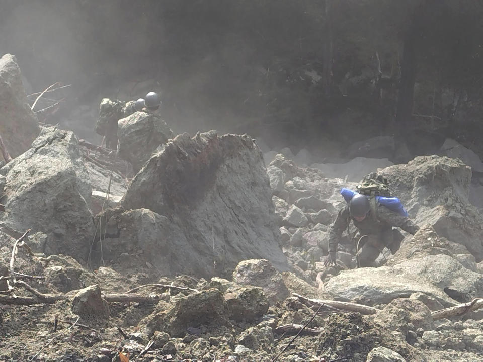 In this photo provided by Japanese Ministry of Defense, members of Japan Self-Defense Forces carry relief goods in Suzu, Ishikawa prefecture, Japan Saturday, Jan. 6, 2024. (Japanese Ministry of Defense via AP)