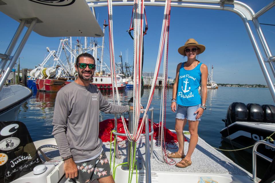 CJ and Libby Titmas, owners of Point Pleasant Parasail, prepare their boat and equipment for a day of parasail excursions in Point Pleasant Beach, NJ Thursday, June 30, 2022. 