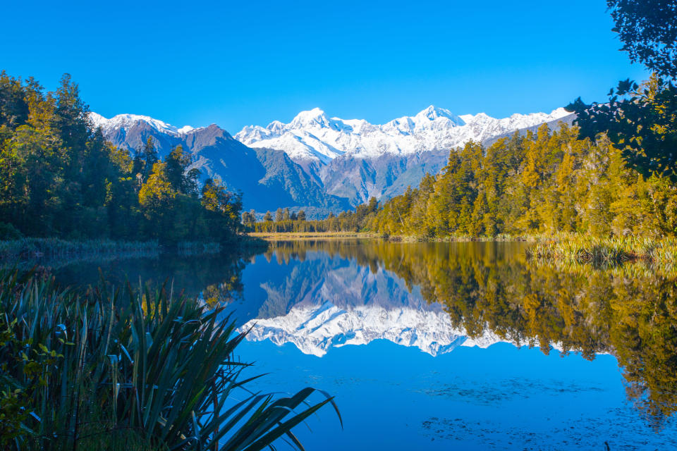 Reflection of mountains in Lake Matheson, New Zealand. (Photo: Gettyimages)