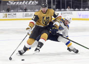 Vegas Golden Knights center Jonathan Marchessault (81) fends off St. Louis Blues defenseman Jake Walman (46) during the second period of an NHL hockey game Saturday, May 8, 2021, in Las Vegas. (AP Photo/David Becker)