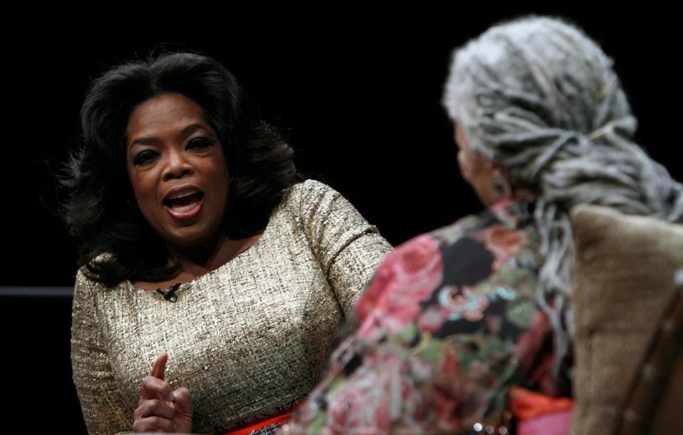 Oprah Winfrey talks with author Toni Morrison at an awards dinner in 2010.