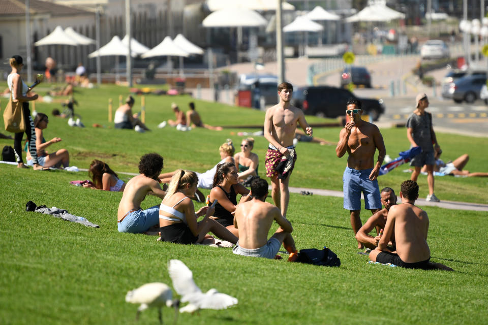 Tourists on the grass at Bondi Beach in Sydney. Source: AAP