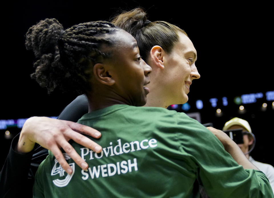 New York Liberty forward Breanna Stewart, right, hugs a former teammate, Seattle Storm guard Jewell Loyd, before a WNBA basketball game Tuesday, May 30, 2023, in Seattle. (AP Photo/Lindsey Wasson)