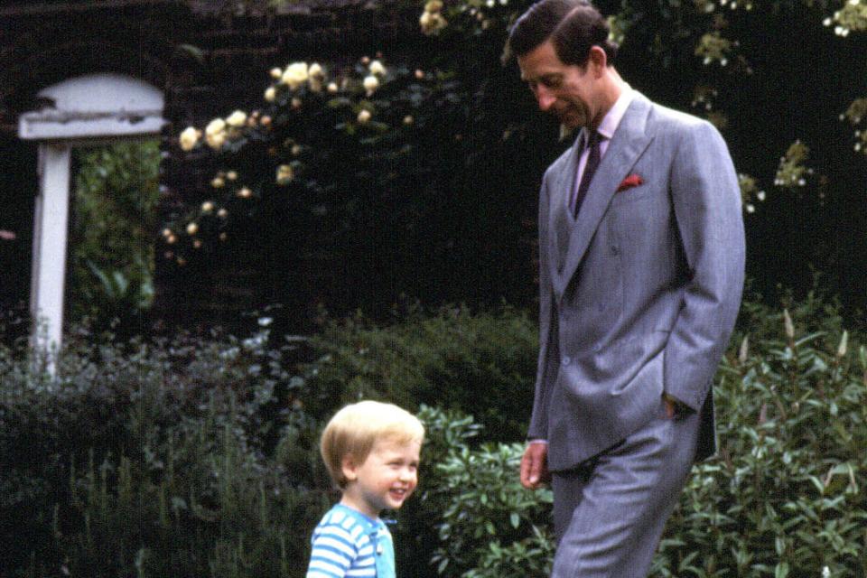 Photo from 1984 of William playing football in the garden of Kensington Palace with his father Charles (PA) (PA Wire)