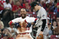 St. Louis Cardinals' Edmundo Sosa (63) celebrates along side Miami Marlins third baseman Brian Anderson, right, after hitting a triple during the fifth inning of a baseball game Wednesday, June 29, 2022, in St. Louis. (AP Photo/Jeff Roberson)