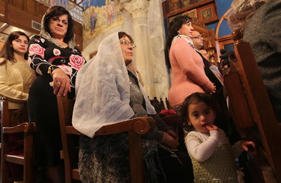 Palestinian Orthodox Christians attend an Orthodox Christmas Mass at the Saint Porphyrius Orthodox Church in Gaza City on Jan. 7, 2016. <a href="https://www.gettyimages.com/detail/news-photo/palestinian-orthodox-christians-attend-an-orthodox-news-photo/503825408?adppopup=true" rel="nofollow noopener" target="_blank" data-ylk="slk:Mohammed Asad/Anadolu Agency/Getty Images;elm:context_link;itc:0;sec:content-canvas" class="link ">Mohammed Asad/Anadolu Agency/Getty Images</a>