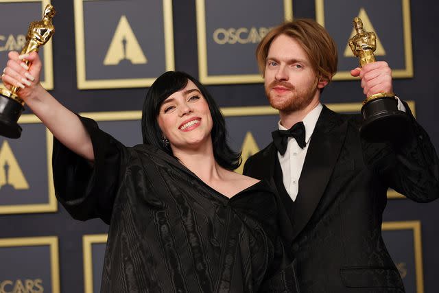 <p>Mike Coppola/Getty</p> Billie Eilish and Finneas in the press room during the Academy Awards in March 2022 in Hollywood
