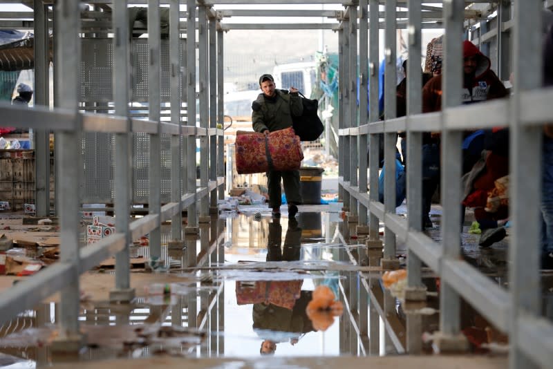 A Palestinian man working in Israel heads to work through an Israeli checkpoint near Hebron in the Israeli-occupied West Bank