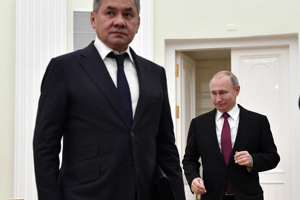 Russian President Vladimir Putin, right, enter a hall as Defense Minister Sergei Shoigu gets ready for the beginning of the Russia-Turkey talks in the Kremlin iin Moscow, Russia, Wednesday, Jan. 23, 2019. Russia and Turkey are jockeying for clout in Syria as the U.S. plans to withdraw its troops from the country. (Alexander Nemenov/Pool Photo via AP)