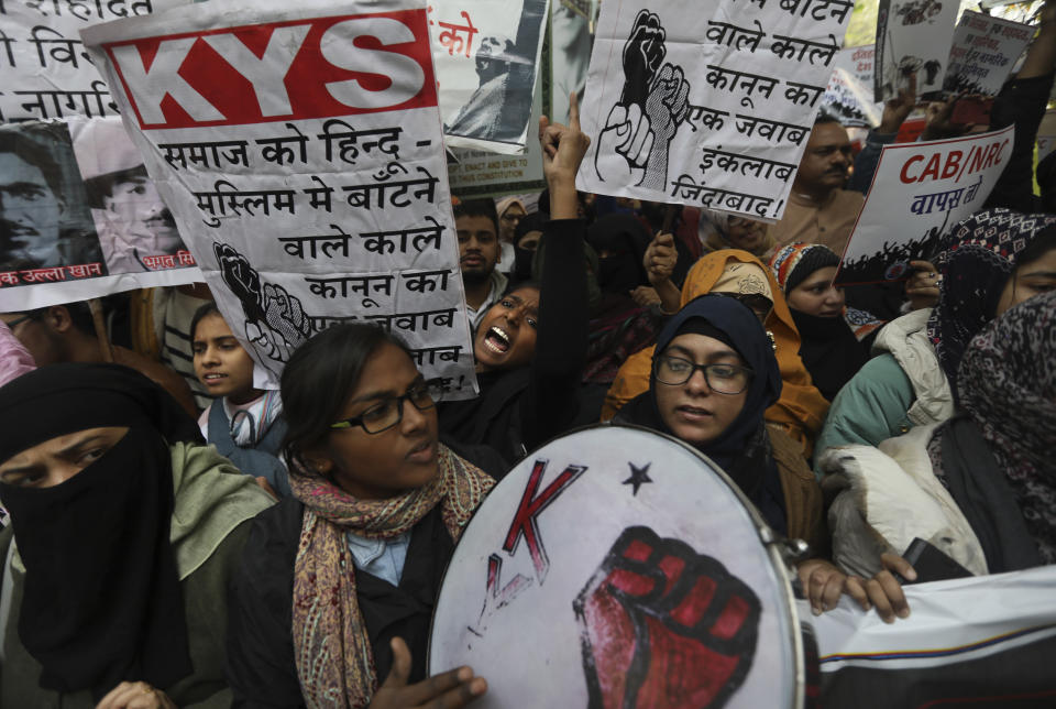 Students shout slogans against government during a protest against a new citizenship law in New Delhi, India, Tuesday, Dec. 24, 2019. Hundreds of students marched Tuesday through the streets of New Delhi to Jantar Mantar, an area designated for protests near Parliament, against the new citizenship law, that allows Hindus, Christians and other religious minorities who are in India illegally to become citizens if they can show they were persecuted because of their religion in Muslim-majority Bangladesh, Pakistan and Afghanistan. It does not apply to Muslims. The banners read down with the new law that creates bifurcation between Hindu and Muslims in the society. (AP Photo/Manish Swarup)