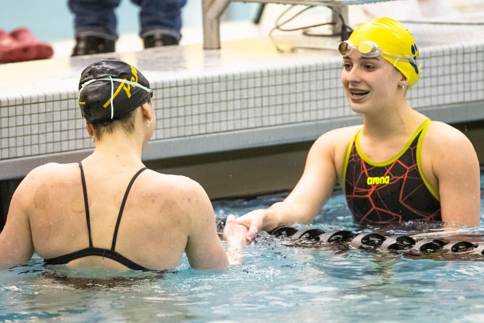 Riley’s Celeste Hollis shakes hands with Penn’s Lilian Christianson after the 50-yard freestyle during the girls sectional swimming preliminaries Thursday, Feb. 2, 2023 at Penn High School.