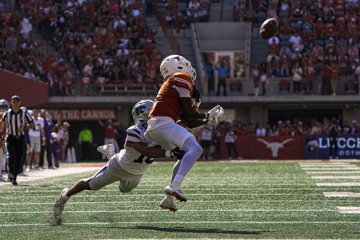 Texas wide receiver Xavier Worthy braces to make a catch during Saturday's 33-30 overtime win over Kansas State. The pass, defended by Wildcats cornerback Jacob Parrish, ended up incomplete.