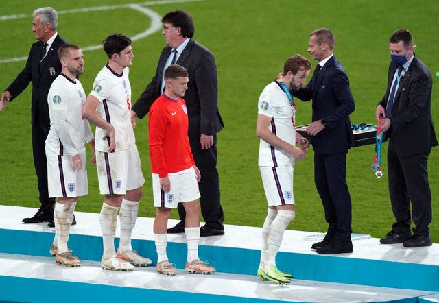 A devastated Harry Kane receives his Euro 2020 runners-up medal from Aleksander Ceferin