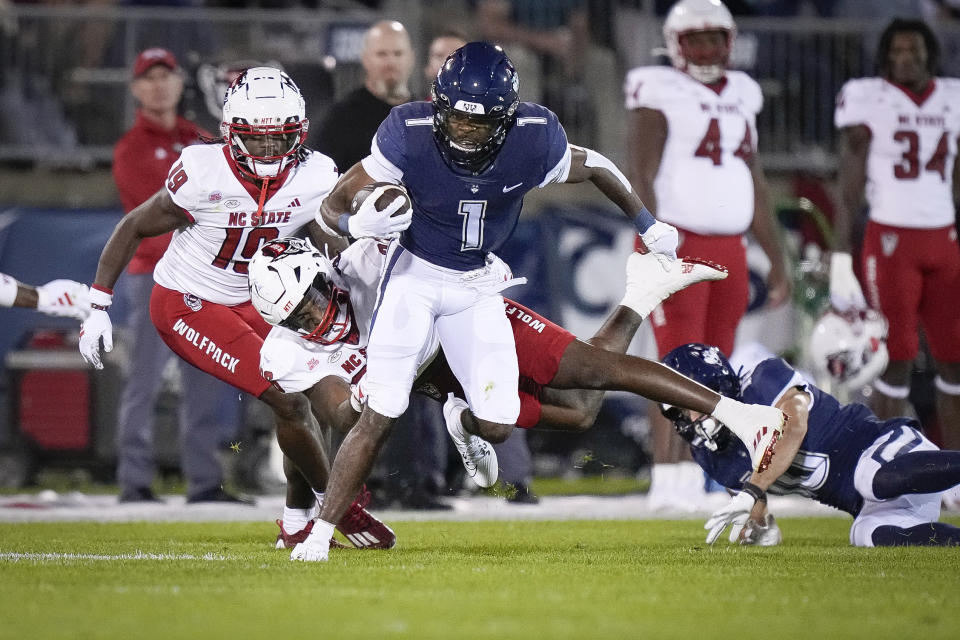 UConn running back Devontae Houston (1) runs with the ball during the first half the team's NCAA college football game against North Carolina State in East Hartford, Conn., Thursday, Aug. 31, 2023. (AP Photo/Bryan Woolston)