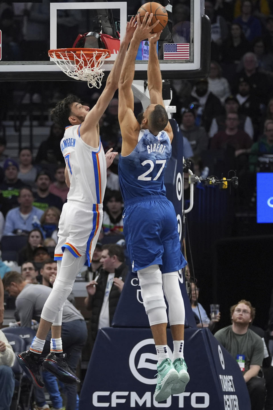 Oklahoma City Thunder forward Chet Holmgren, left, blocks a shot by Minnesota Timberwolves center Rudy Gobert (27) during the second half of an NBA basketball game, Saturday, Jan. 20, 2024, in Minneapolis. (AP Photo/Abbie Parr)