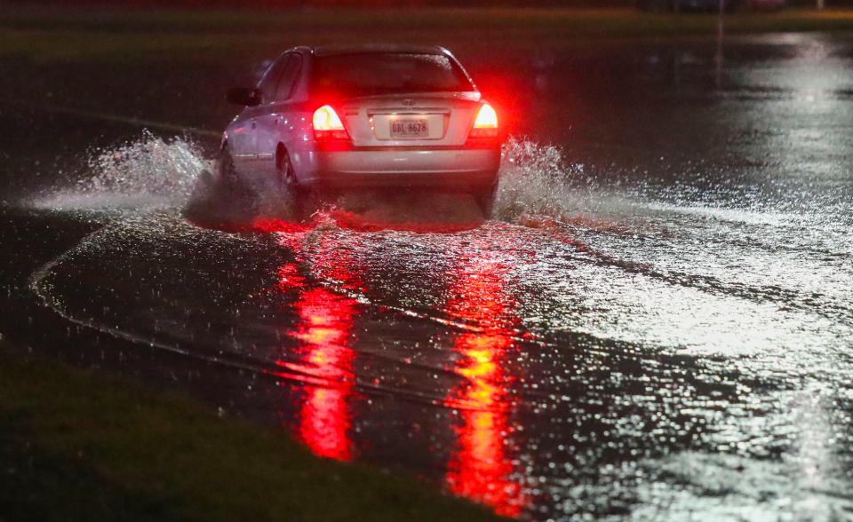 A car tests the waters on Route 13 northbound at the I-495 interchange late Tuesday evening, January 9, 2024 as a storm brings high winds and heavy rain to Delaware.