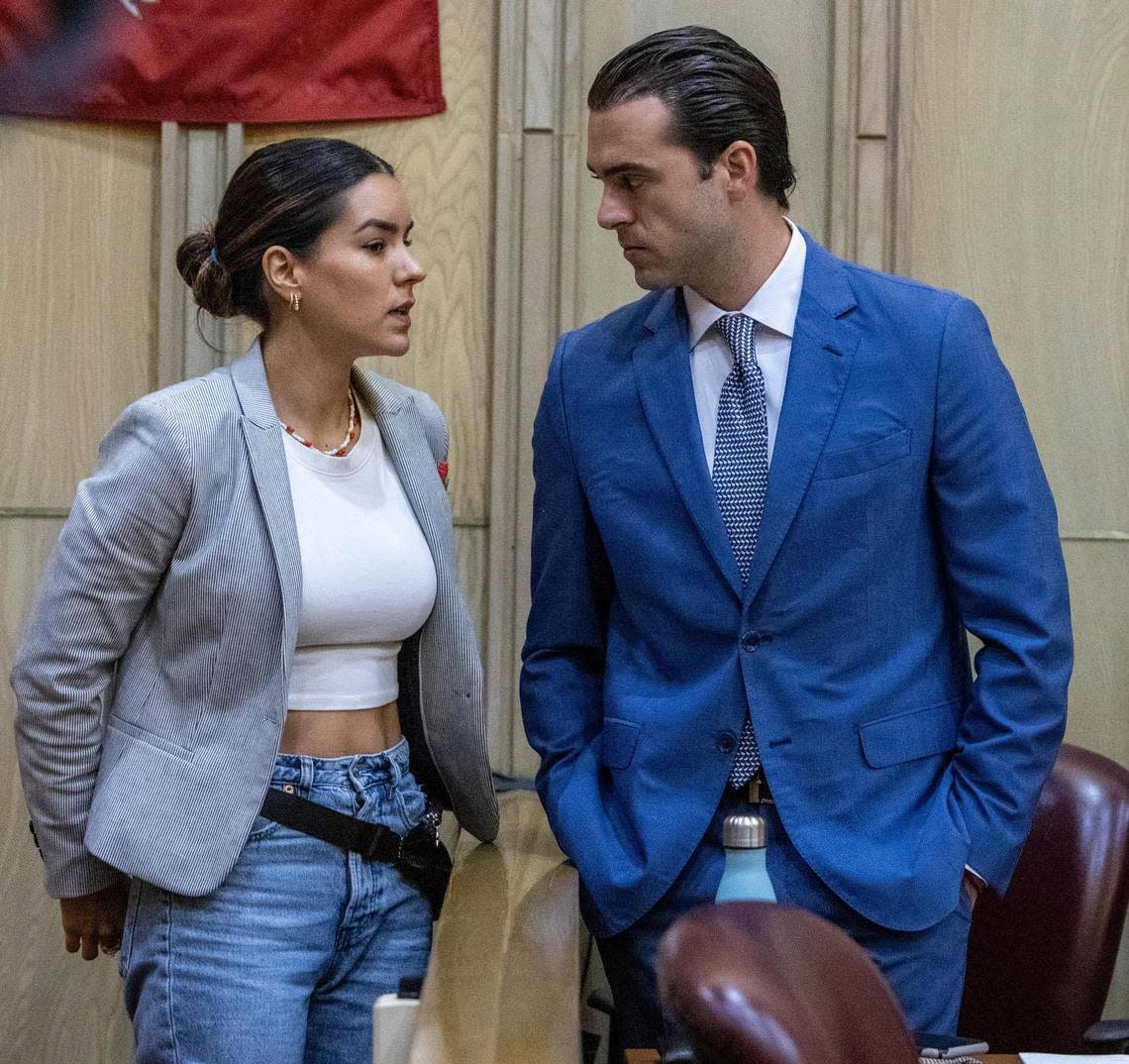 Pablo Lyle, right, talks to his wife, Ana Araujo, left, in Miami-Dade Criminal Court on Oct. 4, 2022. Pablo Lyle is accused of killing 63-year-old Juan Ricardo Hernandez during a road rage incident in 2019.