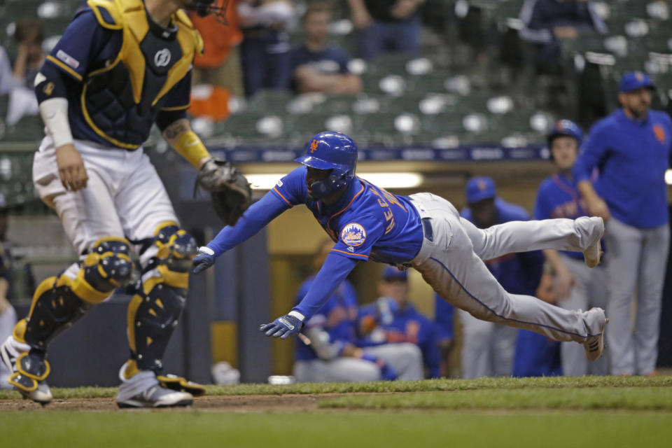 New York Mets' Adeiny Hechavarria scores against the Milwaukee Brewers during the 18th inning of a baseball game Saturday, May 4, 2019, in Milwaukee. (AP Photo/Jeffrey Phelps)