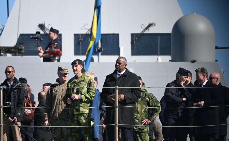 Supreme Commander of the Swedish Armed Forces General Micael Byden (center left) and U.S. Secretary of Defense Lloyd Austin (center right) aboard the <em>Visby</em> class corvette HSwMS <em>Härnösand</em> at the Musko Naval Base, south of Stockholm, in April 2023. <em>Photo by FREDRIK SANDBERG/TT NEWS AGENCY/AFP via Getty Images</em>