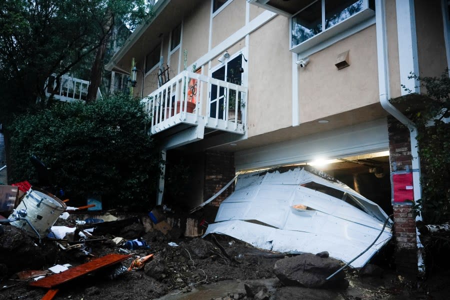 A garage door is damaged by a storm on a home, Monday, Feb. 5, 2024, in Studio City, Calif. The second of back-to-back atmospheric rivers took aim at Southern California, unleashing mudslides, flooding roadways and knocking out power as the soggy state braced for another day of heavy rains. (AP Photo/Marcio Jose Sanchez)